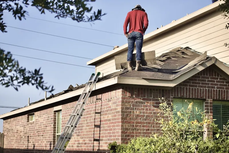 Professional roofer working on a residential roof in University of Texas-Austin